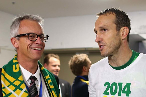 Football Australia CEO David Gallop talks to Mark Schwarzer in the Socceroos changeroom after the victory over Iraq.