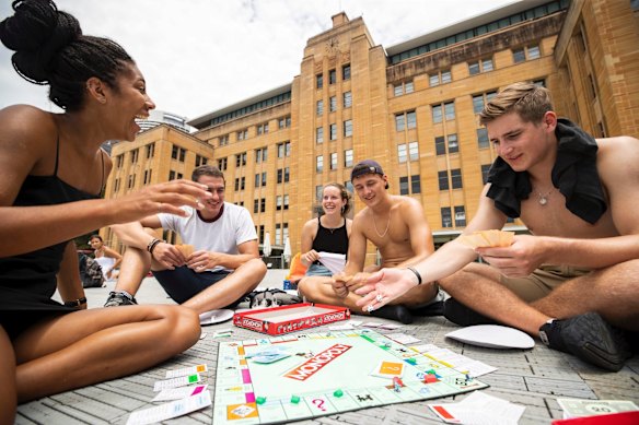 German backpackers get involved in a game of Monopoly in front of the MCA as they wait for the fireworks to start.