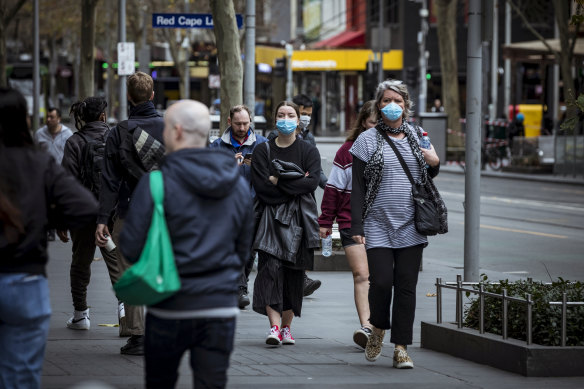 Melburnians wearing face masks in the city on Sunday.