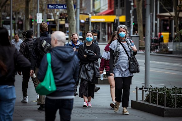 Melburnians wearing face masks in the city on Sunday.