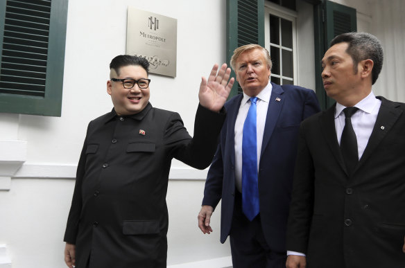 President Donald Trump impersonator Russell White, and North Korean leader Kim Jong-un impersonator Howard X pose for photos outside the Opera House in Hanoi.