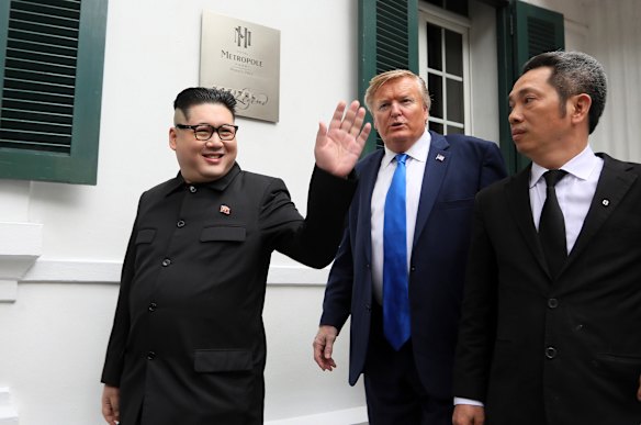 President Donald Trump impersonator Russell White, and North Korean leader Kim Jong-un impersonator Howard X pose for photos outside the Opera House in Hanoi.