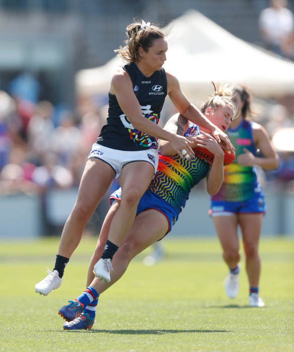 Fearsome bump: The physicality was on show in the AFLW with Bulldog Hannah Scott colliding with Carlton's Nicola Stevens.