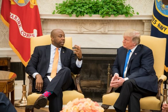 Donald Trump, US president at the time, speaks to Senator Tim Scott during a meeting at the White House in 2017.