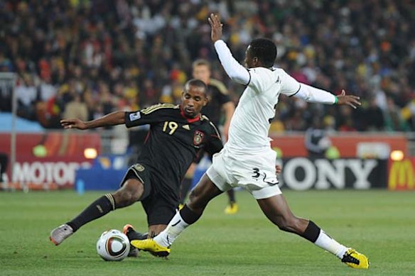 Ghana's striker Asamoah Gyan (R) fights for the ball with Germany's striker Cacau.