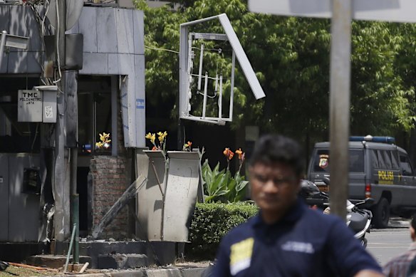 Indonesia Police make line near one of location bomb in Jakarta, Indonesia, Thursday, Jan. 14, 2016. Suicide bombers exploded themselves in downtown Jakarta on Thursday while gunmen attacked a police post nearby, a witness told The Associated Press.