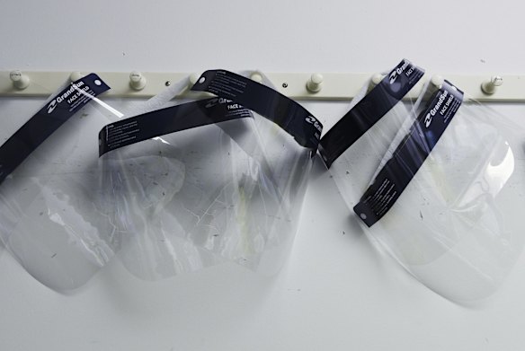 Face shields hang on the wall in the Virology Laboratory.