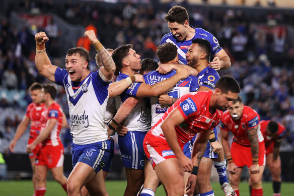 Bulldogs players celebrate a try in the win over the Dragons.