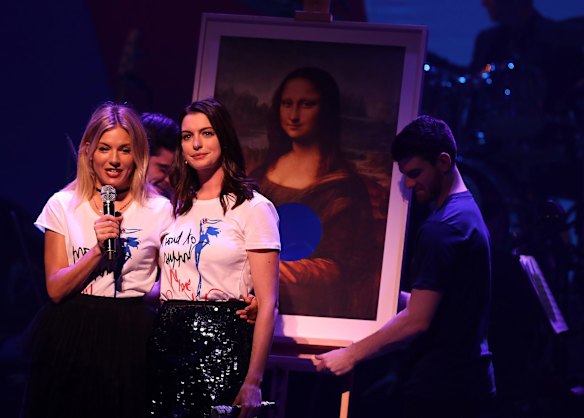 Sienna Miller (L) and Anne Hathaway perform during the Hillary Victory Fund - Stronger Together concert at St. James Theatre on Broadway.