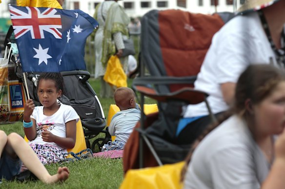 Akon Baak, 7, of Crystalbrook playing with an Australian flag. 