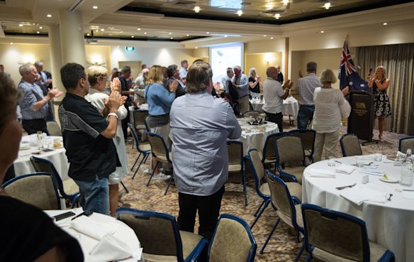 Supporters give a standing ovation to Kirralie Smith after she spoke.