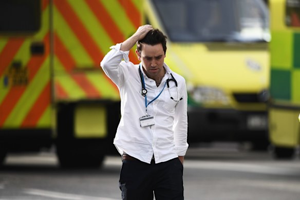 A medic is seen near Westminster Bridge and the Houses of Parliament.