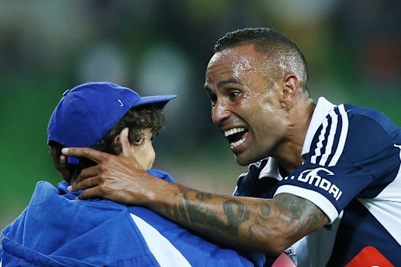 Family occasion: Celebrating with his son Axel after scoring against the Central Coast Mariners at AAMI Park.