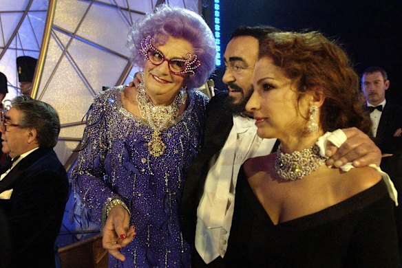 Barry Humphries, aka Dame Edna Everage, left, with singers Luciano Pavarotti, centre, and Gloria Estefan at the Festival Theatre, in Edinburgh, for the start of the 75th Royal Variety performance, Monday Nov.  24, 2003.