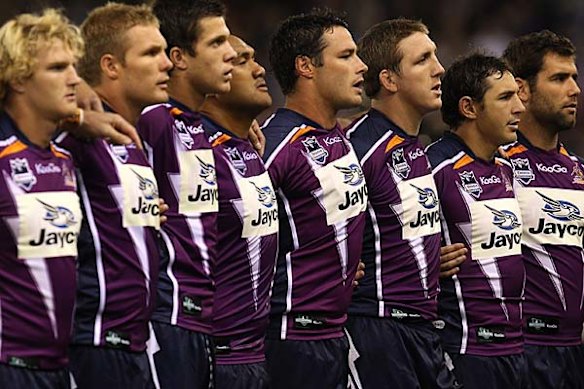 Melbourne Storm players stand for the minute silence.