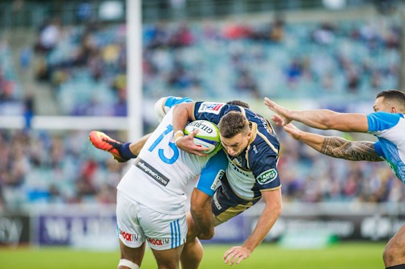 Brumbies flyhalf Wharenui Hawera gets dumped by Blues' outside centre George Moala