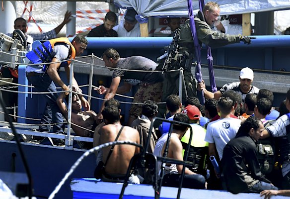 A refugee lays unconscious on the gangway of the Swedish Coast Guard ship as they rescue a total of 441 people.