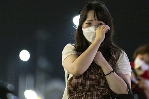 A woman mourns at the site of the shooting.