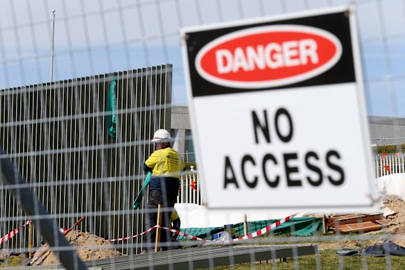 A security fence is installed across the lawns of Parliament House.