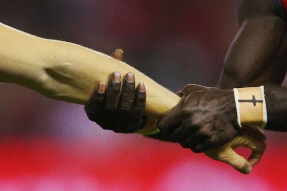  "Everything changed when I accepted God into my life," says McDonald-Tipungwuti, who wears a cross on his  wrist tape.