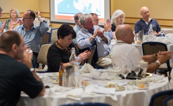 Supporters at the  fundraiser applaud a speaker.