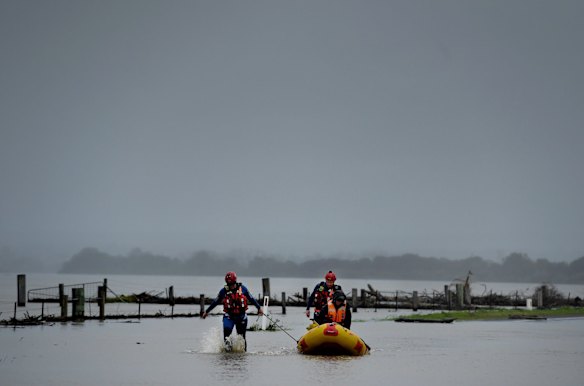 SES crew members make their way through the floodwaters in Shoalhaven Heads, NSW.