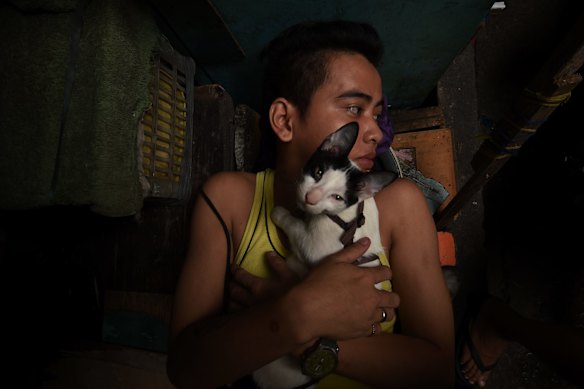 An inmates embraces a kitten as he rests in Quezon city jail, Philippines. 