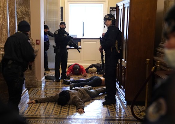 US Capitol Police detain protesters outside the House Chamber during a joint session of Congress.