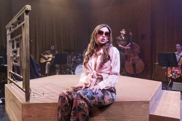 Erin Clare, is alone on a small platform stage, surrounded by the band who are dressed (delightfully) in period costume at Hayes Theatre’s latest production.