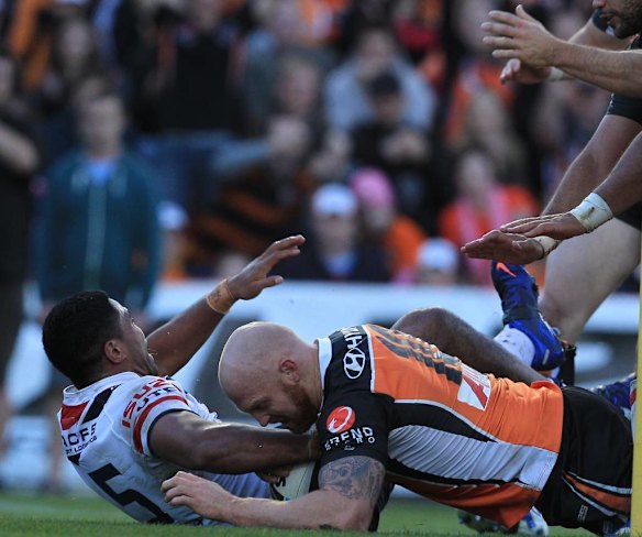 The Tigers' Keith Galloway inspects the grass.