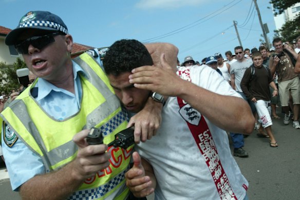 A police officer rescues a  man at North Cronulla.