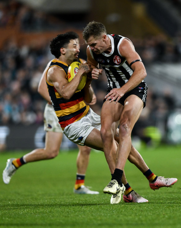 Izak Rankine of the Crows is knocked out after a collision with Dan Houston of the Power.