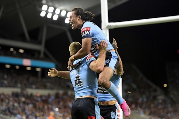 Tom Trbojevic of the Blues celebrates with team mates after scoring a try during game one.