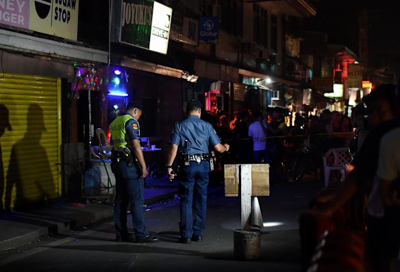 Police at the scene of a double shooting in the Manila suburb of Baclaran, near the airport, where two masked gunmen shot dead two men aged 21 and 35 who were drinking in a bar at 2:40am on Thursday. The death toll in Philippines President Rodrigo Duterte's anti-drugs crackdown is nearing 4,000. Baclaran, Manila, Philippines. 