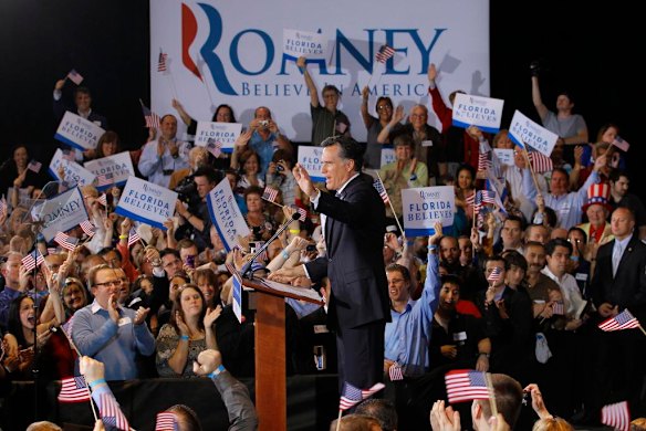 U.S. Republican presidential candidate Mitt Romney waves to the crowd as he speaks at his Florida primary night rally.