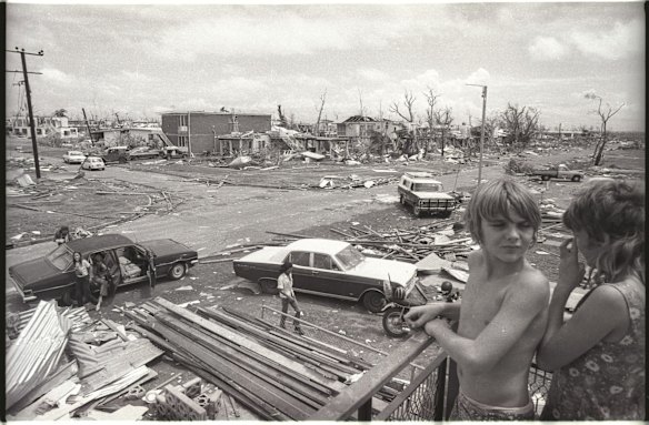Children look on as people inspect the damage from Cyclone Tracy which hit Darwin in 1974.