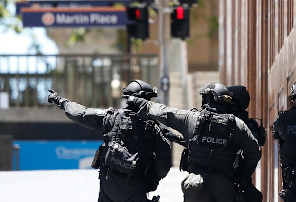 Police take positions during the Martin Place siege.