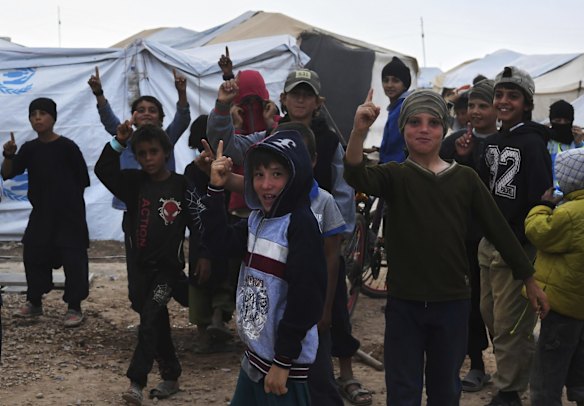 Children make the sign for the Islamic State in the foreign annex of Al-Hawl camp in North East Syria. 