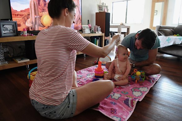Bethan and Johnny McElwee at home with their daughter Aviana McElwee on her first birthday, opening some birthday gifts.