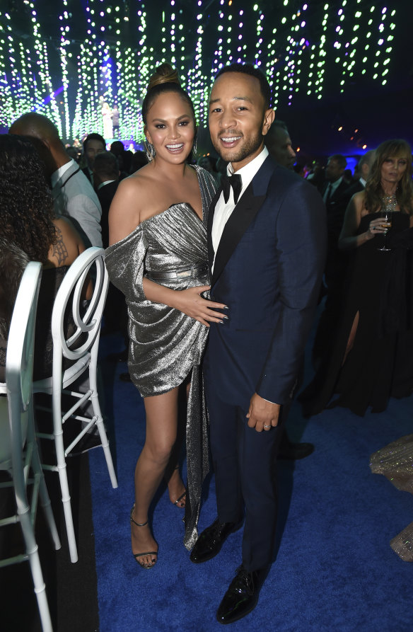 From one silver gown to another ... Chrissy Teigen and John Legend attend the Governors Ball.