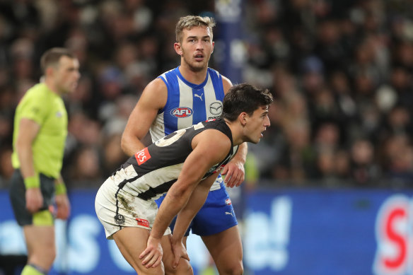 Close check: Reborn Kangaroo Will Phillips keeps a close eye on Nick Daicos.