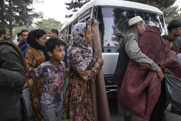 Displaced Afghans from the northern provinces are evacuated from a makeshift IDP camp in Share-e-Naw park to various mosques and schools on August 12, 2021 in Kabul, Afghanistan. People displaced by the Taliban advancing are flooding into the Kabul capital to escape the Taliban takeover of their provinces.