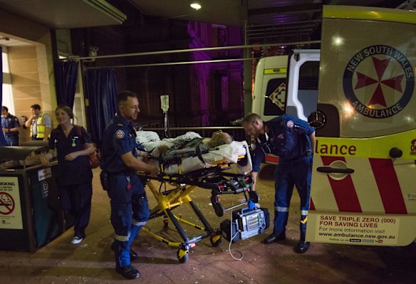 11:18pm. NSW Ambulance Paramedics Eugene Roser (left) and Gareth Garne transport a 70 year old male from Leichhardt, who experienced loss of conciousness and low blood pressure, to RPA Hospital. 