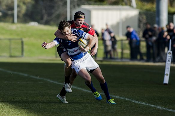 Royals' Ben Johnston tackles Gungahlin's Mitchell Connolly.