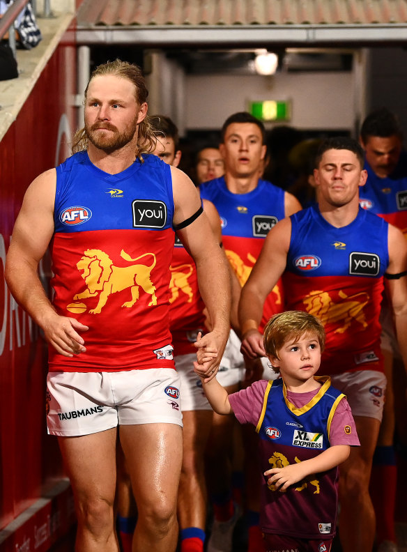 Daniel Rich leads out the Lions.