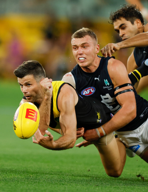 Trent Cotchin is tackled by Patrick Cripps.
