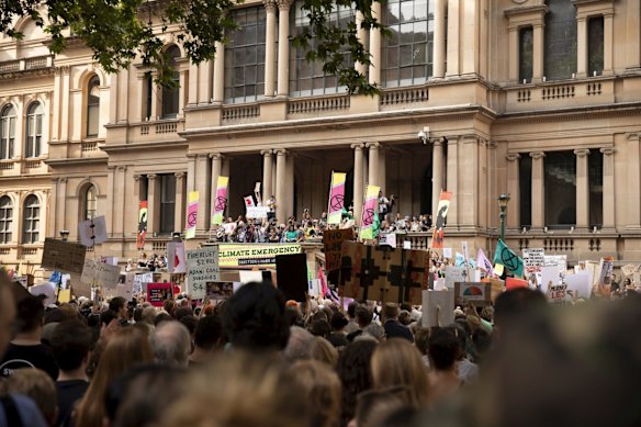 Thousands gather at Town Hall in Sydney CBD to demand action on climate change and the deposition of Prime Minister Scott Morrison on Friday.