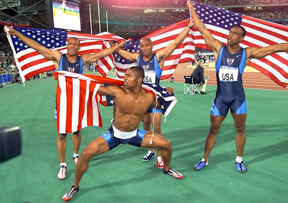 Maurice Greene, top left, Brian Lewis, top centre, Jonathan Drummond, right, and Bernard Williams III, lower center, pose with US flags after winning the gold medal in the men's 4 x 100 metre relay.