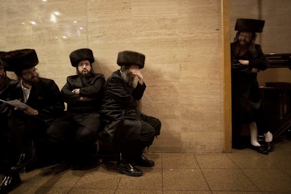 Ultra-Orthodox Jewish men gather at a yeshiva, a rabbinical seminary.