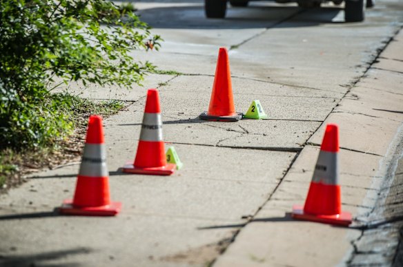 Police officers and forensic staff attend the scene of an overnight shooting and arson attack in Harrington circuit, Kambah. Numerous bullets have hit the home and three vehicles have been set alight. 